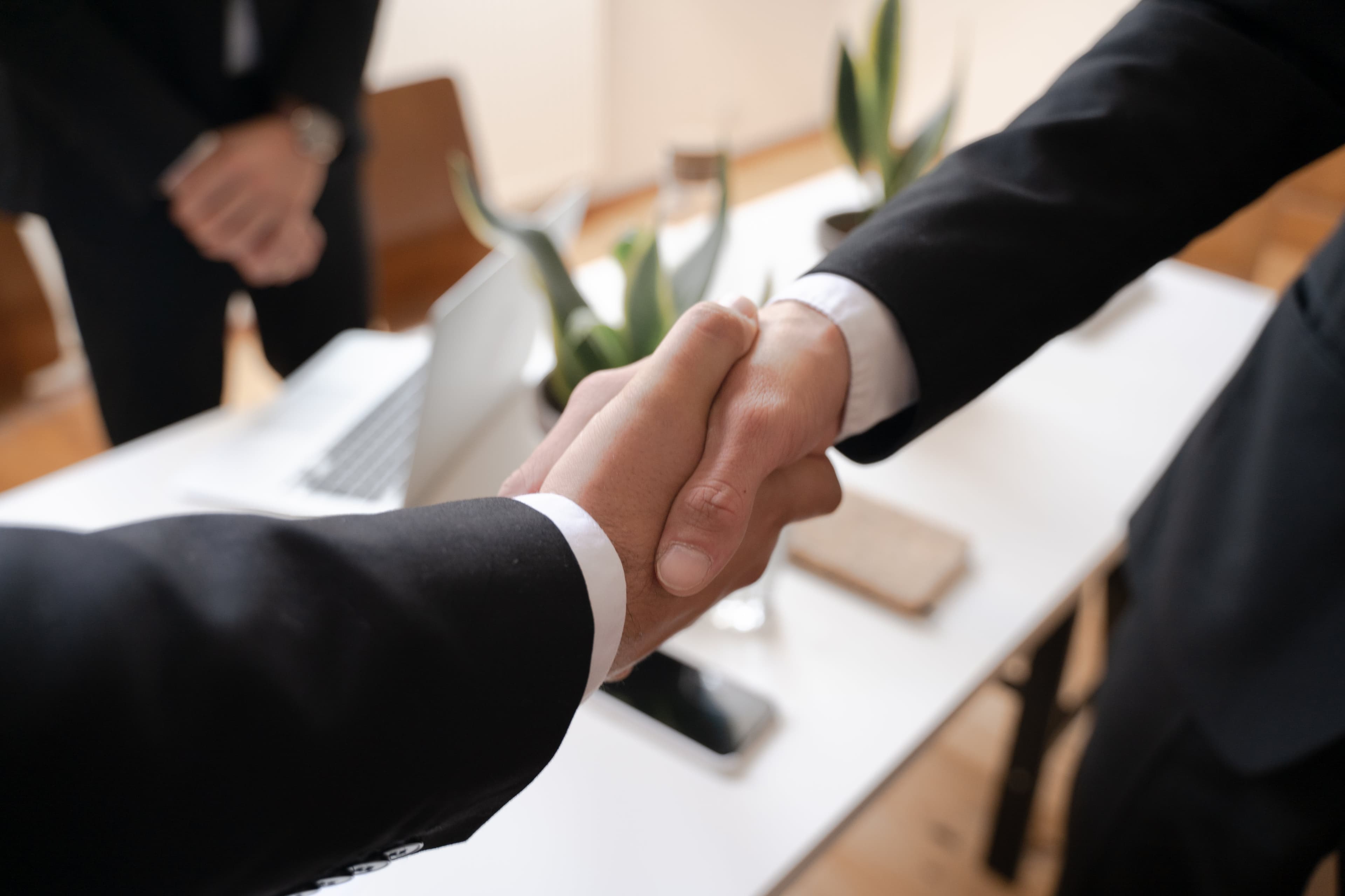 Two business professionals shaking hands in an office