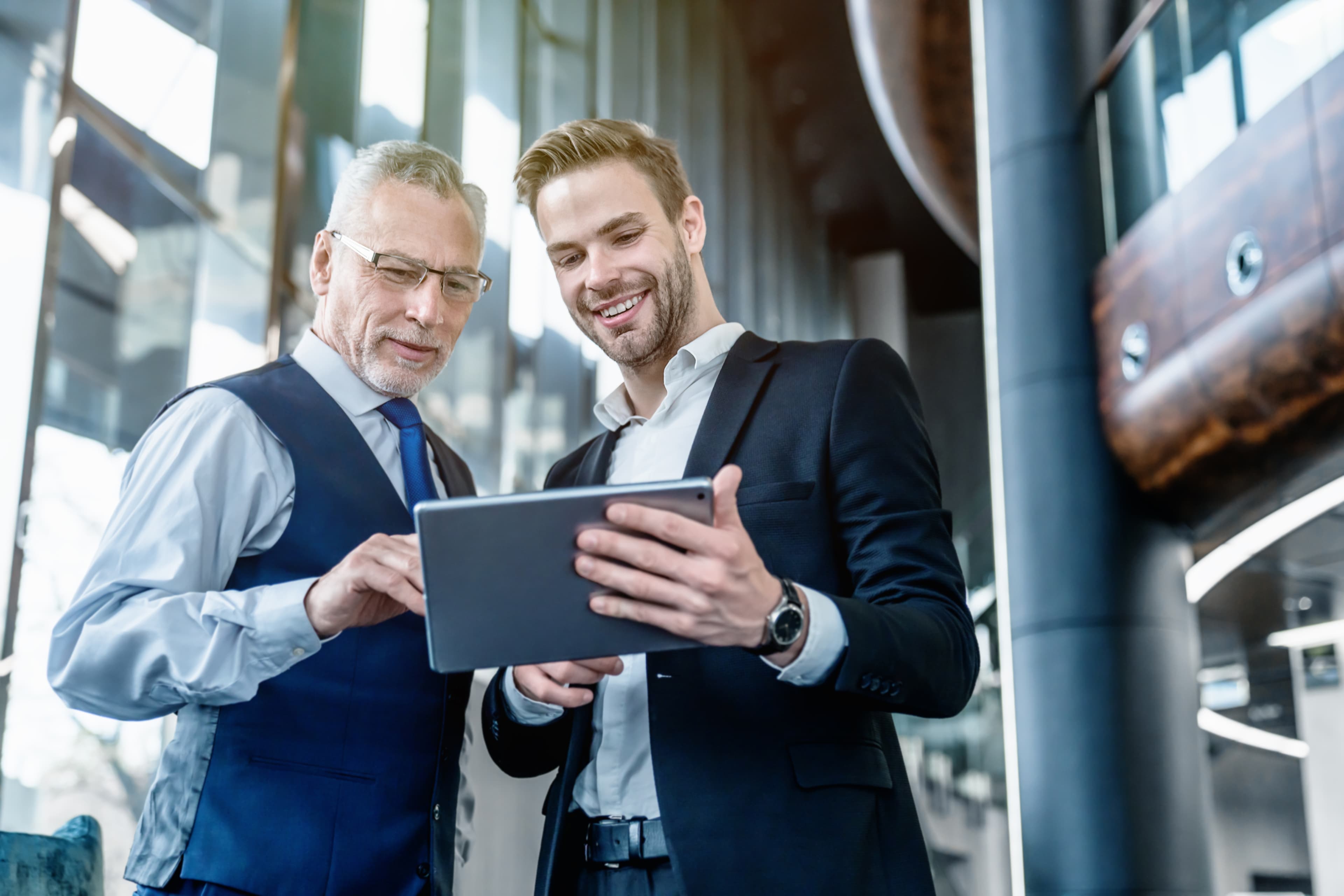 Two business professionals looking at a tablet